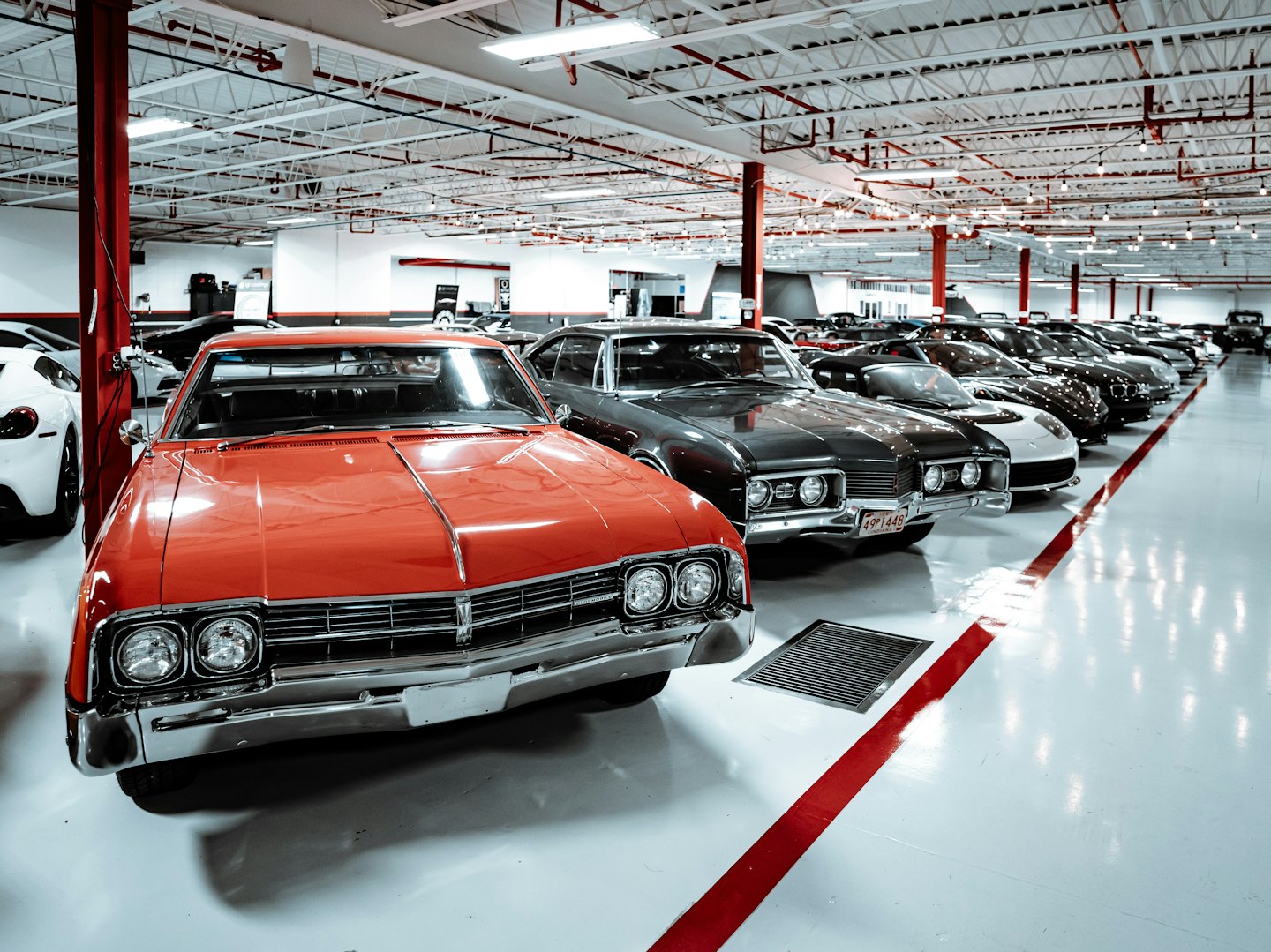 Red vintage sedan parked in a car showroom.